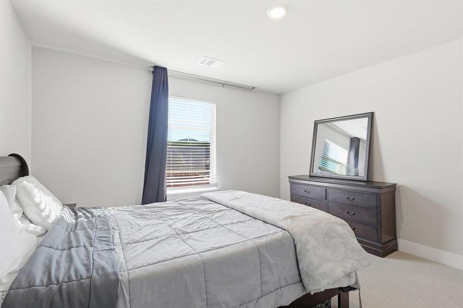 Carpeted bedroom featuring baseboards