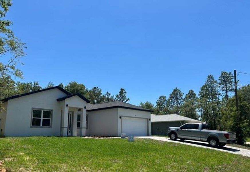 Front exterior of a new home in , Citrus Springs, FL, highlighting curb appeal (Image 23). Front exterior of a new home in , Citrus Springs, FL, highlighting curb appeal (Image 23).