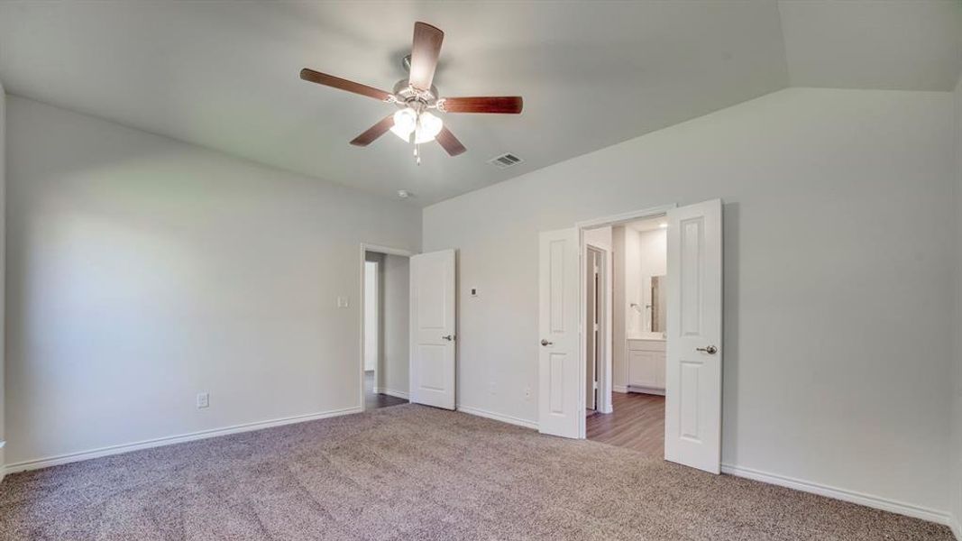 Unfurnished bedroom featuring carpet flooring and ceiling fan