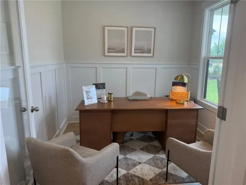 Classic wainscoting paneling and rich wood floorin