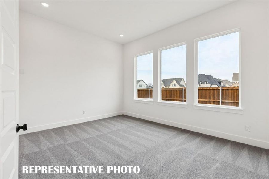 The main floor media room offers the perfect place to host those big game day parties!  REPRESENTATIVE PHOTO