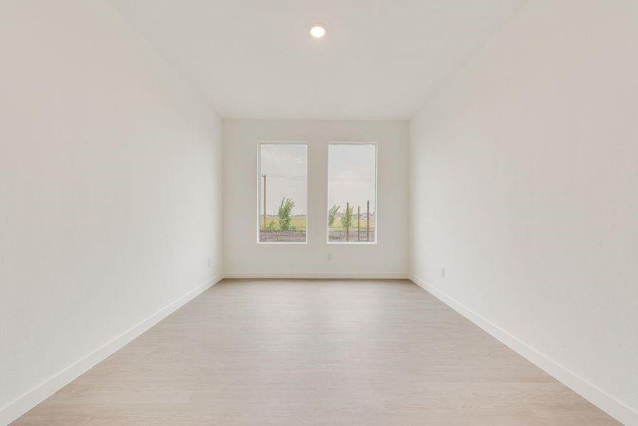 Spare room featuring light wood-type flooring and recessed lighting