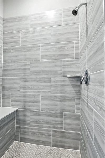 Full bath featuring a shower stall Full bath featuring a shower stall