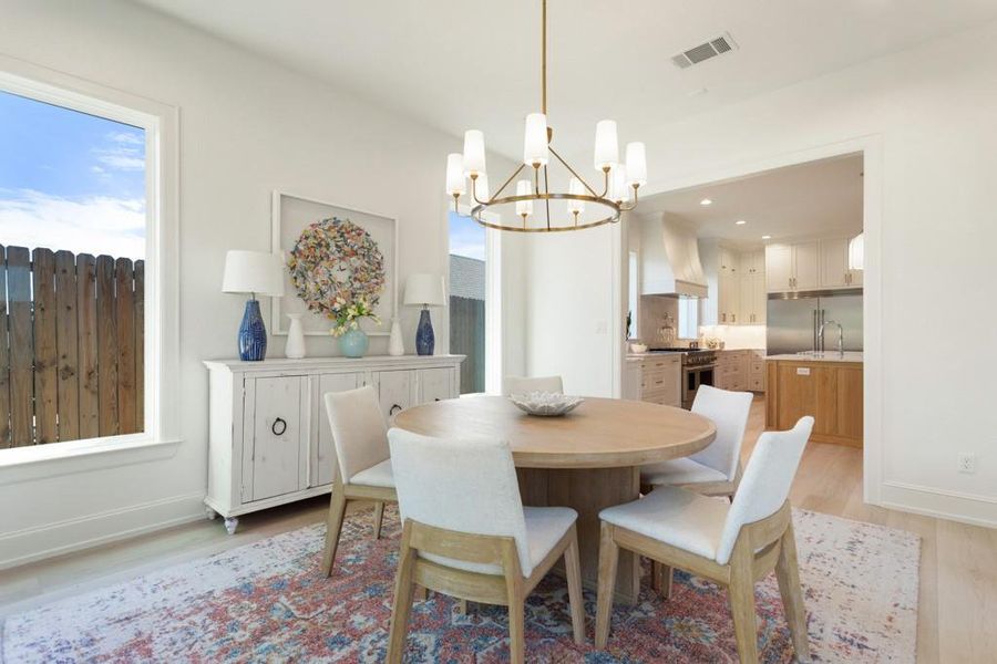 Dining area featuring light wood-type flooring, a chandelier, and recessed lighting