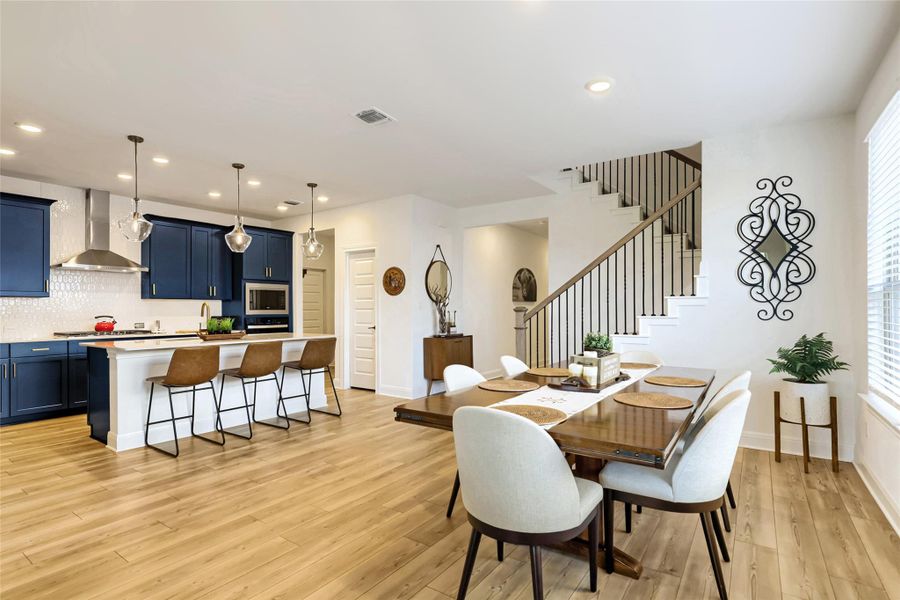 An open-concept living area with a well-appointed kitchen and dining space, perfect for entertaining. An open-concept living area with a well-appointed kitchen and dining space, perfect for entertaining.