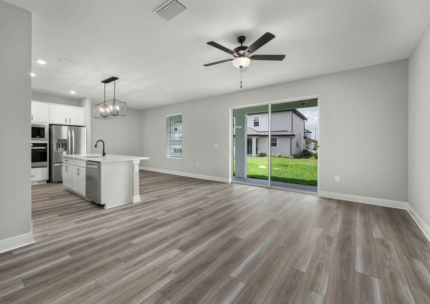 Kitchen, dining room, and family room with a sliding foor the the backyard