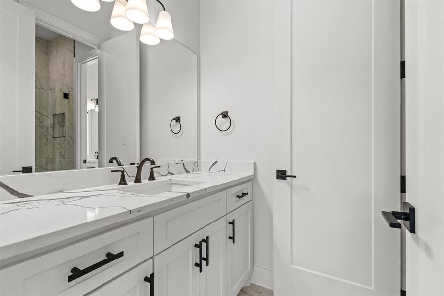 Bathroom featuring vanity and a marble finish shower Bathroom featuring vanity and a marble finish shower