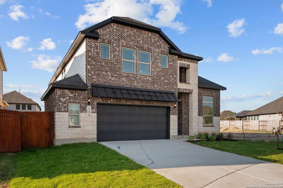 Front exterior of a new home in Stillwater Ranch, San Antonio, TX, highlighting curb appeal (Image 2).