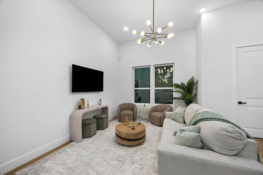 This cozy living room features a modern chandelier, a large sectional sofa, and a wall-mounted TV. Neutral tones and soft lighting create a relaxing atmosphere, complemented by stylish decor and greenery. This cozy living room features a modern chandelier, a large sectional sofa, and a wall-mounted TV. Neutral tones and soft lighting create a relaxing atmosphere, complemented by stylish decor and greenery.