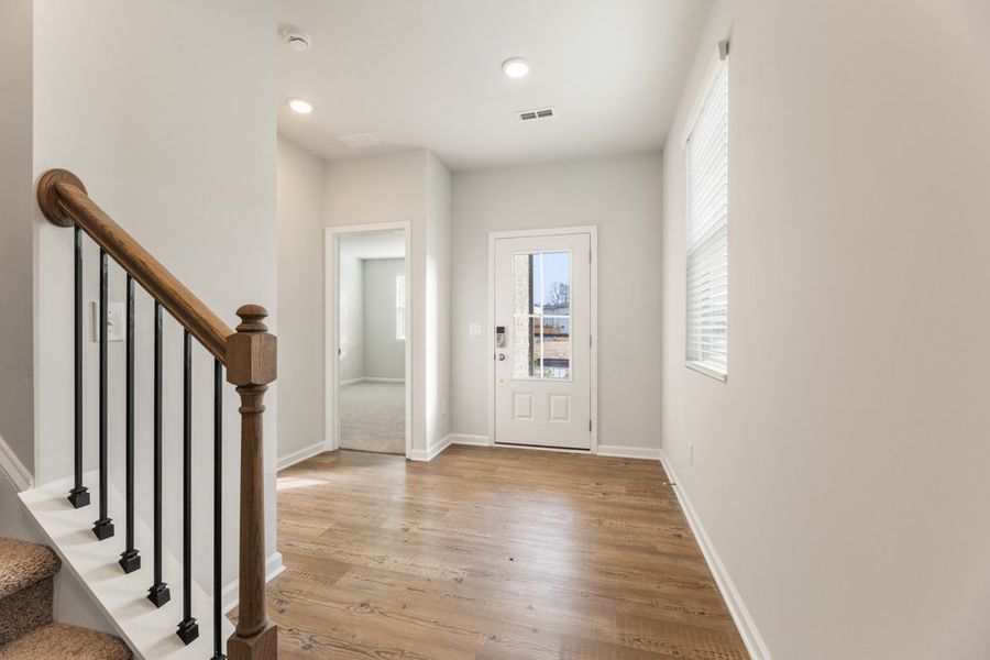A hallway with a wood floor.