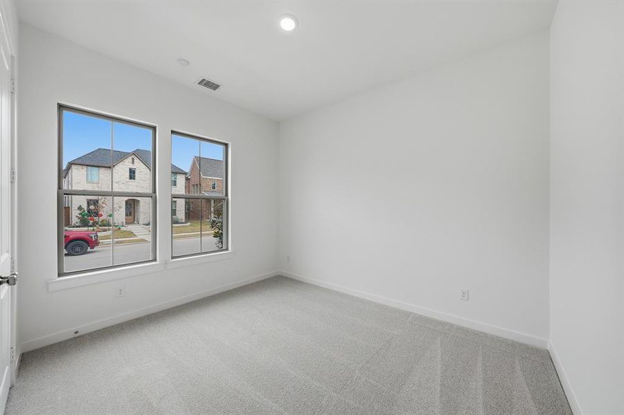 Carpeted spare room with baseboards and recessed lighting