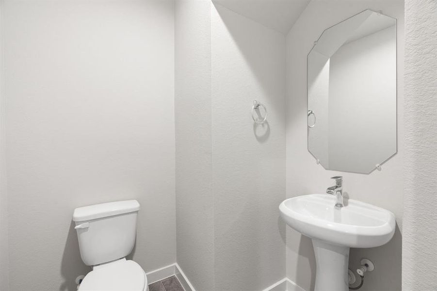 Immerse yourself in modern elegance within this delightful half bathroom. Featuring a sophisticated 5-panel door, upgraded pedestal sink, contemporary hardware.