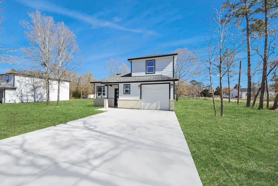 Front exterior of a new home in , Conroe, TX, highlighting curb appeal (Image 2). Front exterior of a new home in , Conroe, TX, highlighting curb appeal (Image 2).