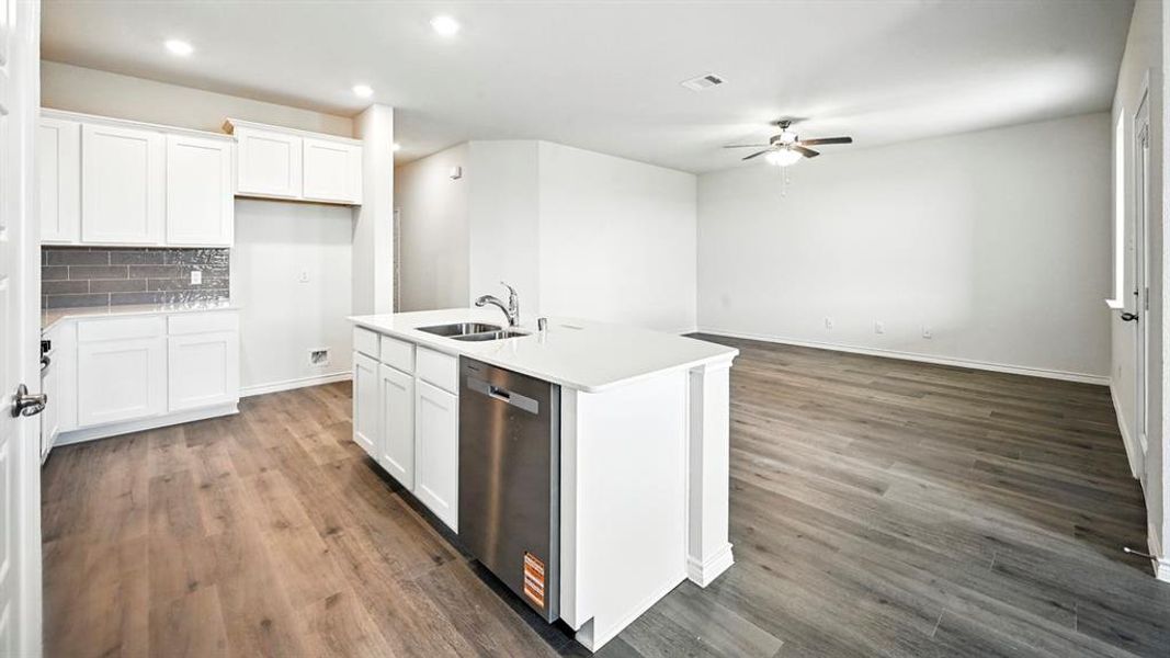 Open-concept living space featuring wood-finish flooring throughout