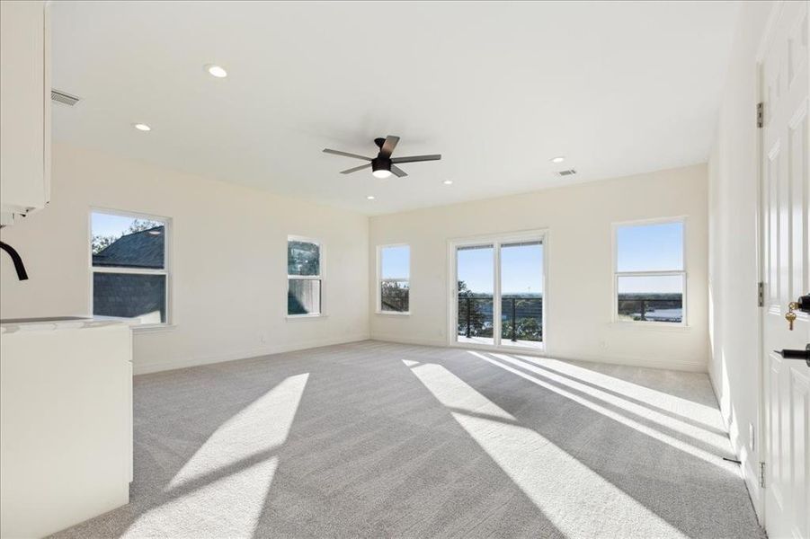 Carpeted spare room with ceiling fan