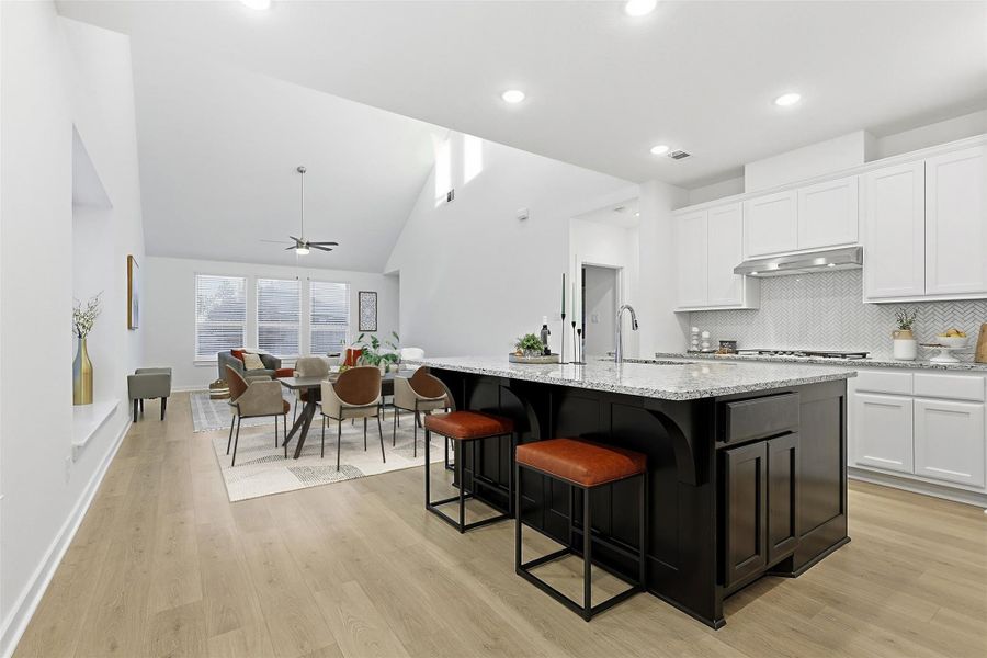 Large island, kitchen is open to the family room (dining table virtually staged for illustration) Large island, kitchen is open to the family room (dining table virtually staged for illustration)