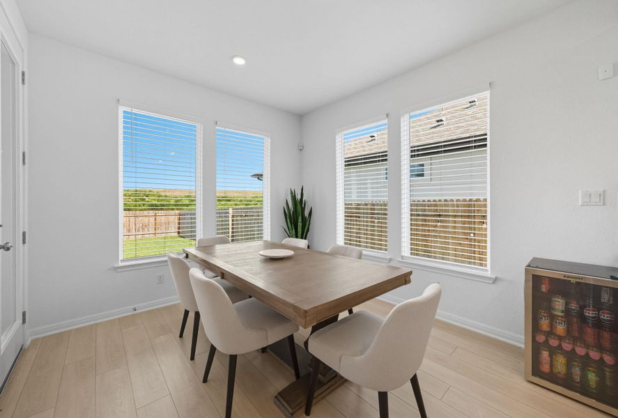 Dining area with light wood finished floors, plenty of natural light, and recessed lighting Dining area with light wood finished floors, plenty of natural light, and recessed lighting