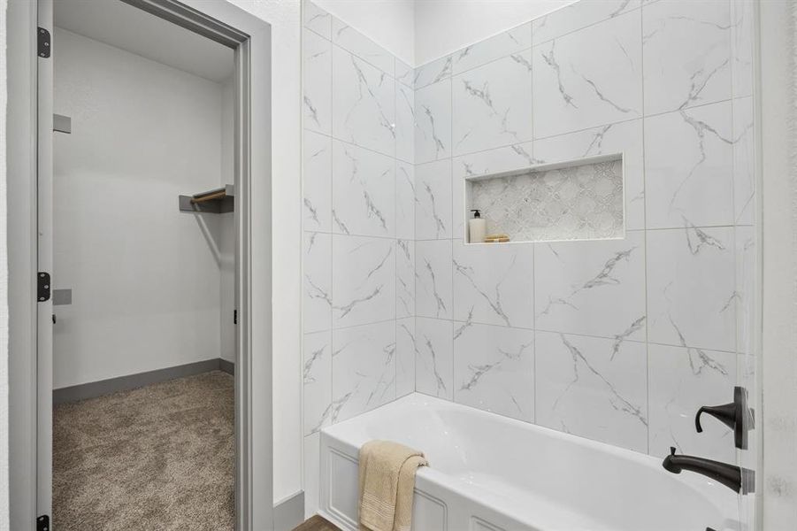 You can see the additional tub/shower and the door to the primary closet