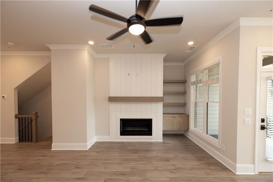 Fireplace -42" Ventless Fireplace with shiplap surround and built-in cabinet with floating shelves.