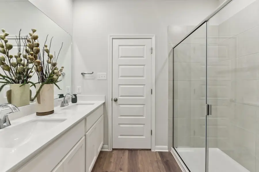 A bathroom with a glass shower. A bathroom with a glass shower.