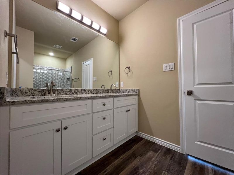 Full Bath featuring Double Vanity with Granite Countertop