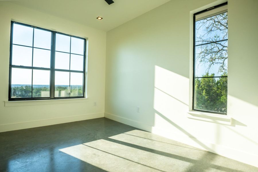 Spare room featuring concrete floors and baseboards