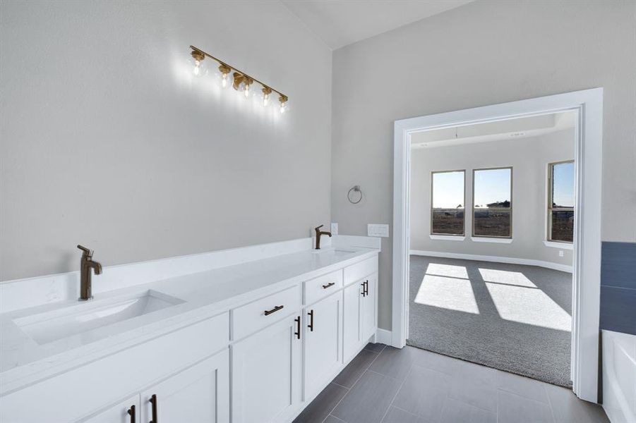 Bathroom featuring dual vanity and tile patterned flooring