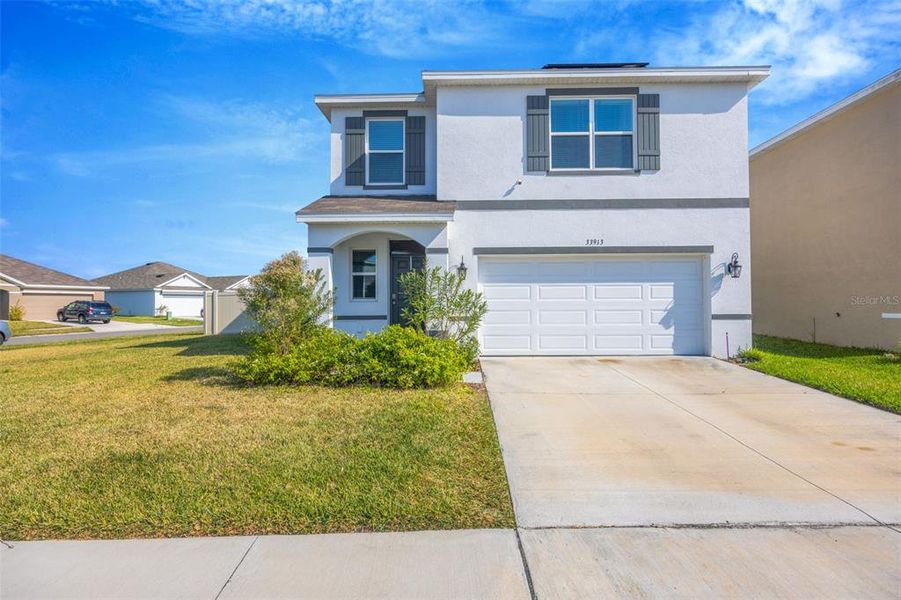 Front exterior of a new home in Summerstone, Wesley Chapel, FL, highlighting curb appeal (Image 2). Front exterior of a new home in Summerstone, Wesley Chapel, FL, highlighting curb appeal (Image 2).
