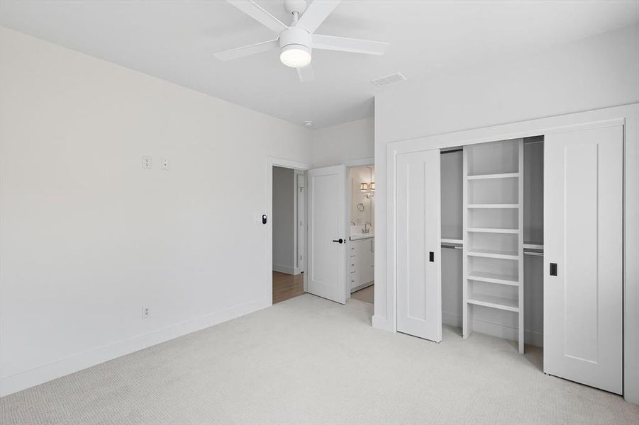 Unfurnished bedroom featuring light colored carpet, a closet, and ceiling fan Unfurnished bedroom featuring light colored carpet, a closet, and ceiling fan