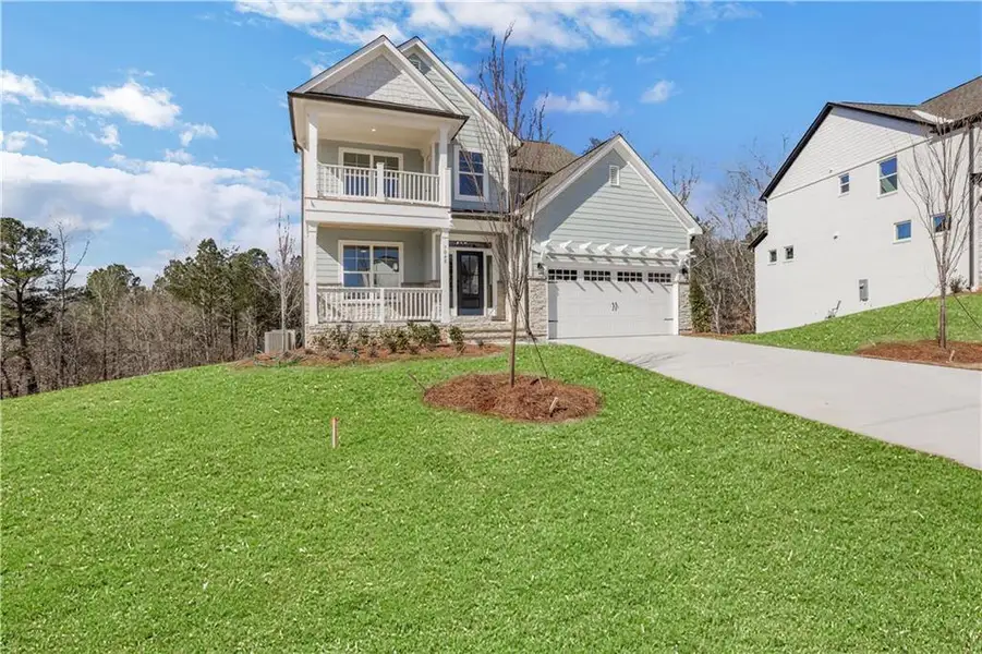 Front exterior of a new home in Cambridge, Flowery Branch, GA, highlighting curb appeal (Image 1). Front exterior of a new home in Cambridge, Flowery Branch, GA, highlighting curb appeal (Image 1).