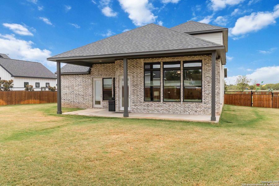 Front exterior of a new home in Woodbridge Farms, La Vernia, TX, highlighting curb appeal (Image 27).