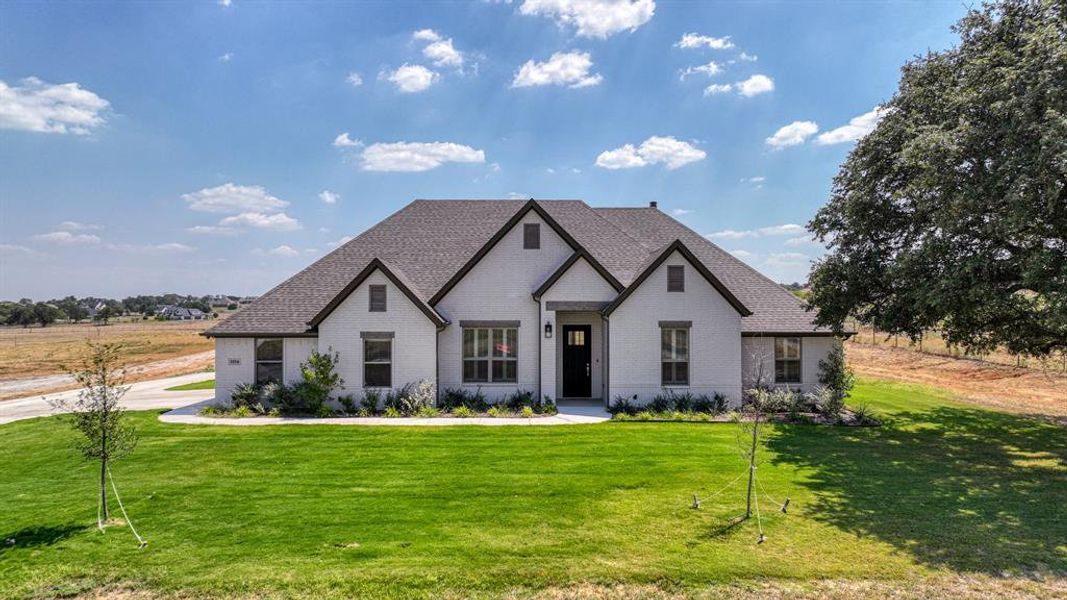 View of front facade featuring a front yard and a rural view