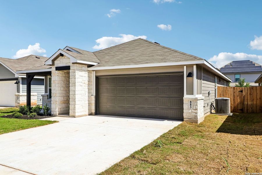 Front exterior of a new home in Estancia Ranch - Premier Series, San Antonio, TX, highlighting curb appeal (Image 2). Front exterior of a new home in Estancia Ranch - Premier Series, San Antonio, TX, highlighting curb appeal (Image 2).