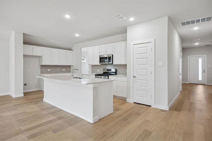 Kitchen in the Heisman home plan by Trophy Signature Homes – REPRESENTATIVE PHOTO
