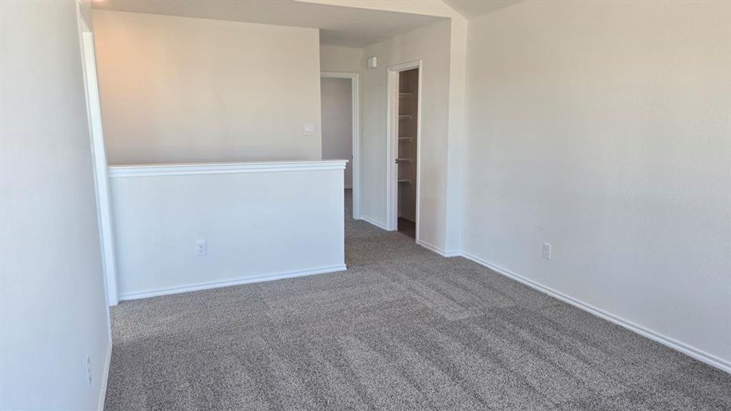 Carpeted spare room with baseboards