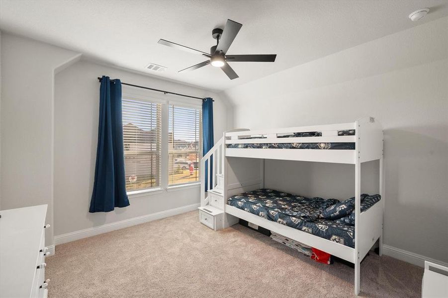 Bedroom with light carpet and ceiling fan