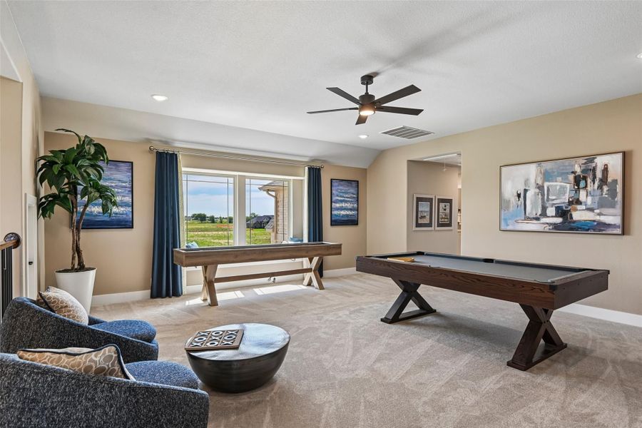 Game room with pool table, shuffleboard, carpet flooring, and ceiling fan Game room with pool table, shuffleboard, carpet flooring, and ceiling fan