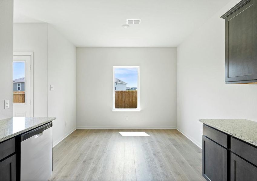 The dining room sits right off of the kitchen and has a large window.