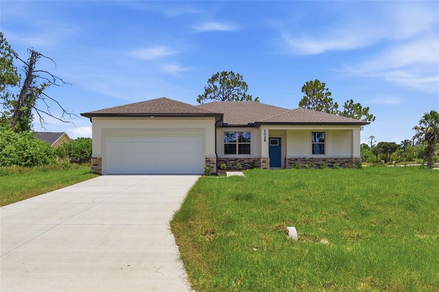 Front exterior of a new home in , North Port, FL, highlighting curb appeal (Image 2). Front exterior of a new home in , North Port, FL, highlighting curb appeal (Image 2).