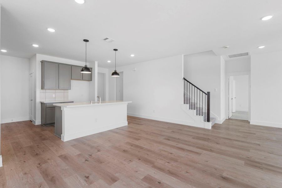 The stairway is tucked away, to not disrupt the open flow of this home.