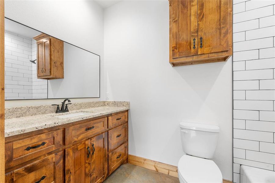 Master bBathroom with toilet, vanity, and baseboards Master bBathroom with toilet, vanity, and baseboards