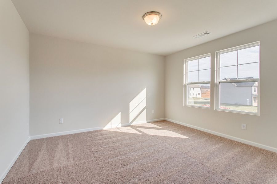 A room with a window and a carpet.