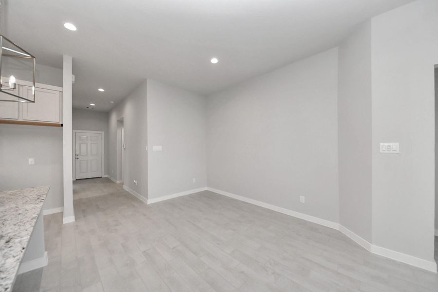 Craft enduring memories with loved ones around the table in this roomy dining area. It boasts stylish flooring, personalized paint, and is conveniently situated next to the family room and kitchen, fostering an open and inclusive ambiance.