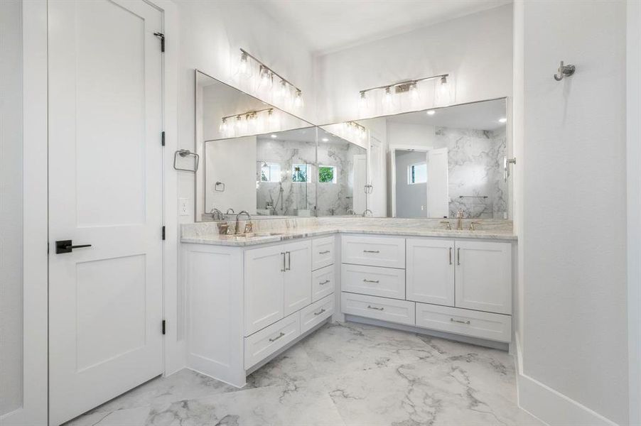 Bathroom featuring vanity and tiled shower