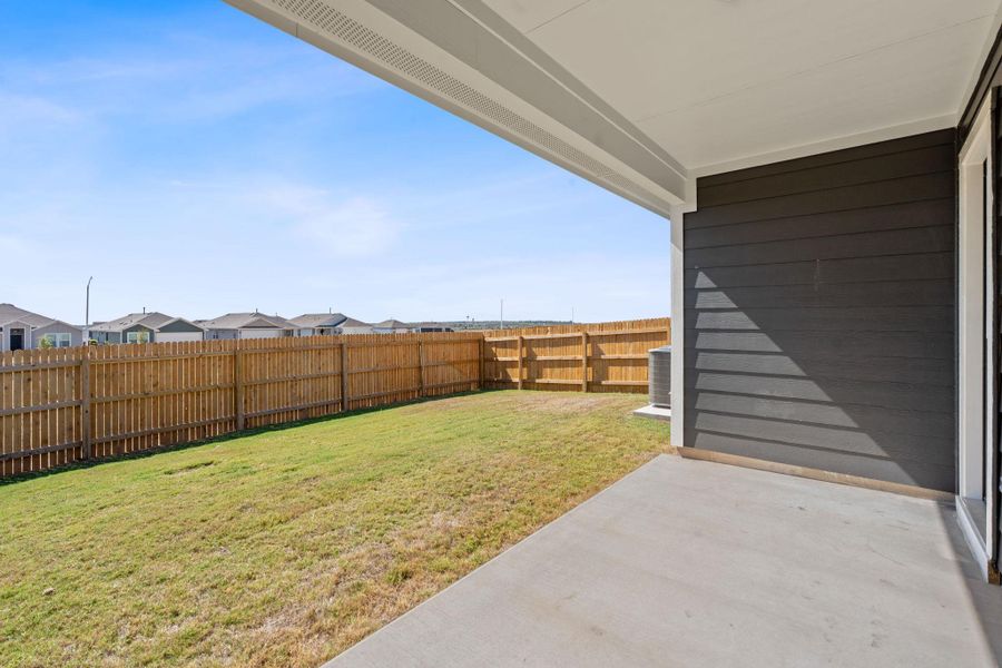 Fenced backyard featuring a patio and a residential view