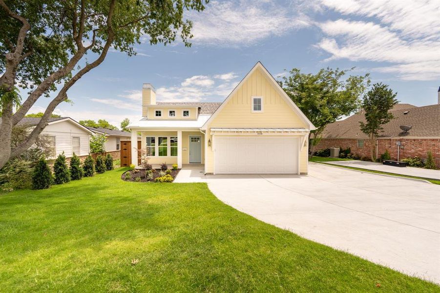 Single-story home featuring light yellow siding, white trim, and a prominent front-facing gable Single-story home featuring light yellow siding, white trim, and a prominent front-facing gable