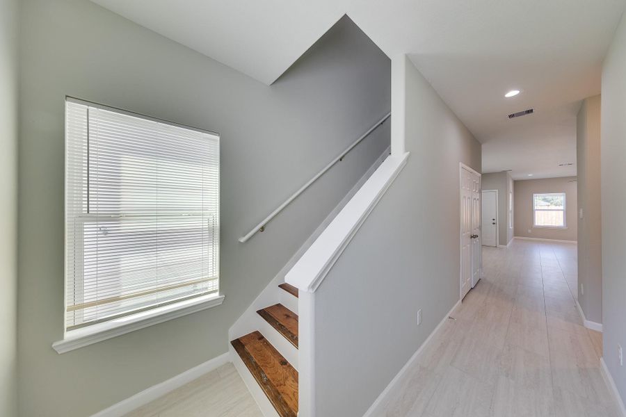 An inviting entrance hallway welcomes you home with a clean, modern aesthetic and a bright, airy feel for guests.