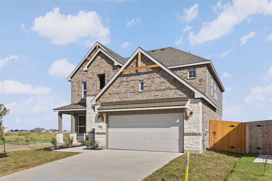 Front exterior of a new home in The Grove at Blackhawk, Pflugerville, TX, highlighting curb appeal (Image 22).