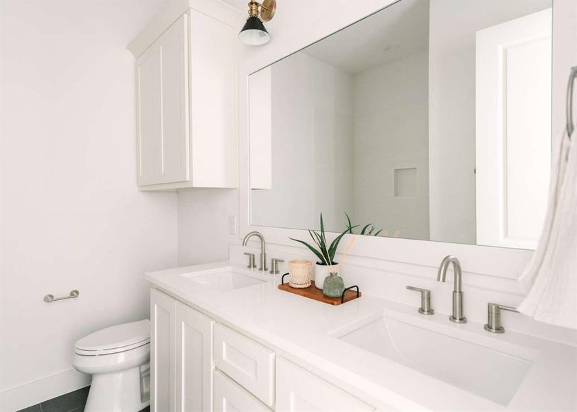 Bathroom with vanity, toilet, and tile patterned floors