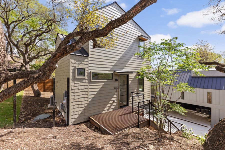 Back of house with a deck